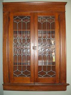 Original leaded glass built-ins with beadboard interior are not an unusual find in our neighborhood.