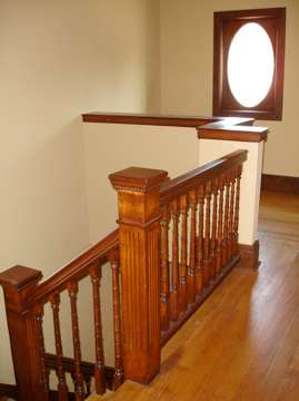 This lovely staircase, hardwoods and the decorative oval window spell charm.